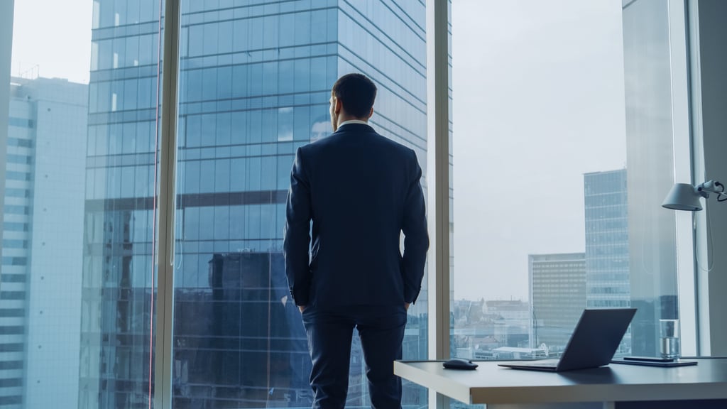 Businessman Looking Out of a Office Window
