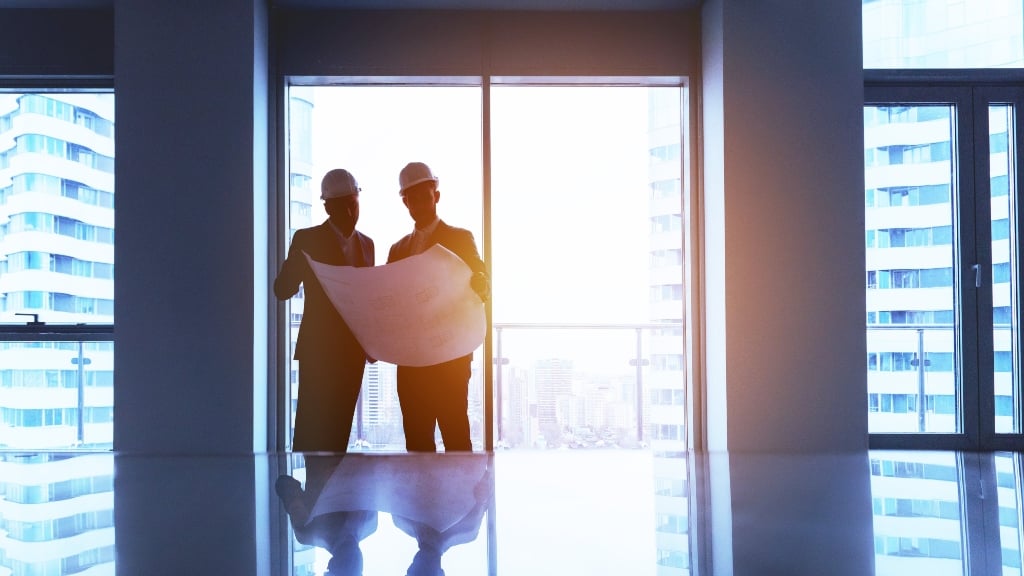 Property Developers Looking At Map in Building